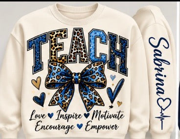 Cream personalized teacher sweatshirt with blue and leopard print TEACH lettering, bow, hearts, and Love Inspire Motivate Encourage Empower text; customizable sleeve name